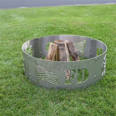 A Metal Fire Pit Sitting On Top Of A Lush Green Field
