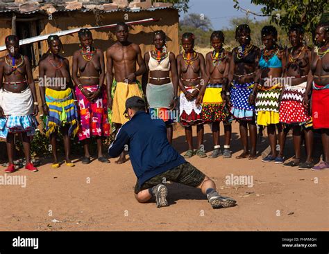 European Tourist Filming Mudimba Tribe Women In Traditional Clothing Cunene Province Cahama