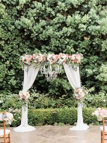 Wedding Ceremony Arch With Draping Fabric And Chandelier Succulents