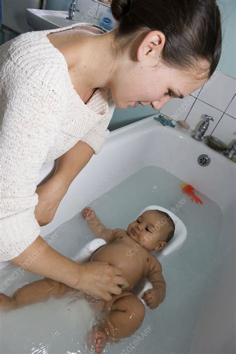 Mother Bathing Her Baby Daughter Stock Image C Science Photo Library