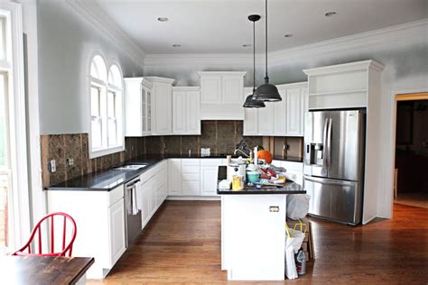 The stainless steel appliances add to the sleek look of this kitchen along with the black and white walls! He's So Metro - Bower Power | Kitchen colors, Home ...