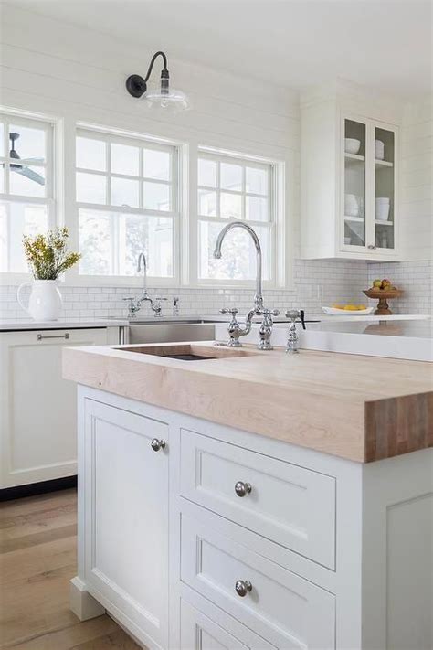 A Butcher Block Prep Island Sits At The End Of A Larger Kitchen Island