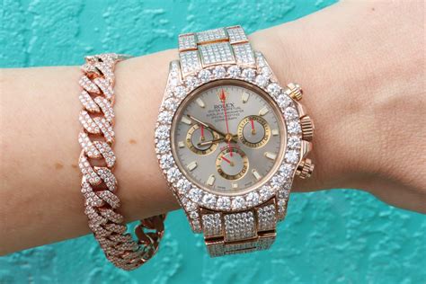 Hand Reaching Out Reference ~ Iced Out Rose Gold Rolex Daytona With Bust Down Cuban Link