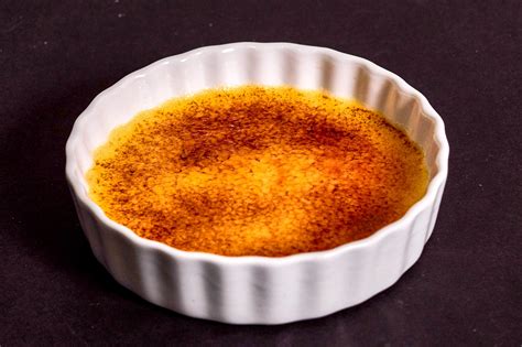 The thin layer of hard caramel is one of the most iconic components of this custard dessert. Classic Crème Brûlée - Three Chicks and a Whisk