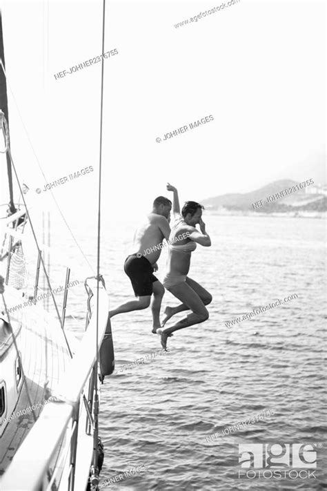 Couple Jumping Into Water From Boat Stock Photo Picture And Royalty