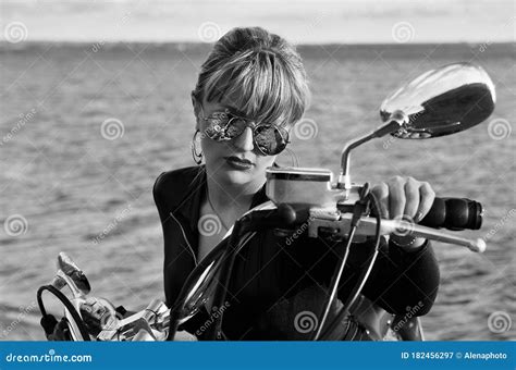 Black And White Photo Of Beautiful Biker Women Posing With Motorcycle