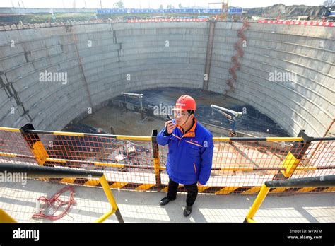 File A Chinese Worker Labors At The Construction Site Of The