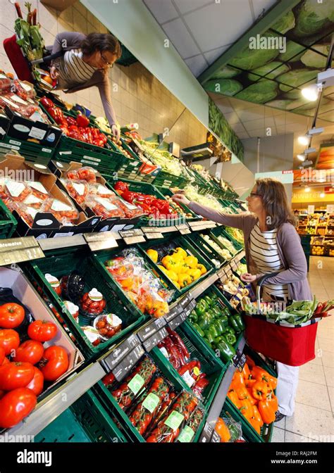 Woman Shopping In The Fruit And Vegetable Section Of A Self Service Grocery Department