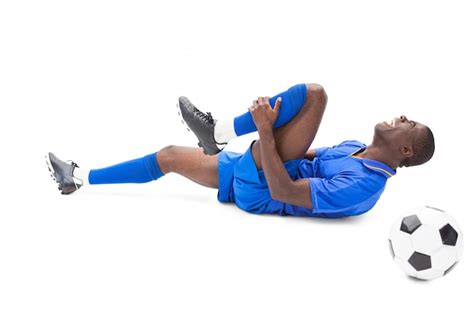 Premium Photo Football Player In Blue Lying Injured On The Pitch