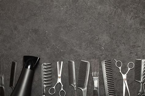 Black Combs And Combs With Scissors On A Black Background Copy Space