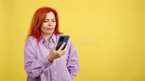redheaded mature woman with hand on face and thoughtful expression stock video video of