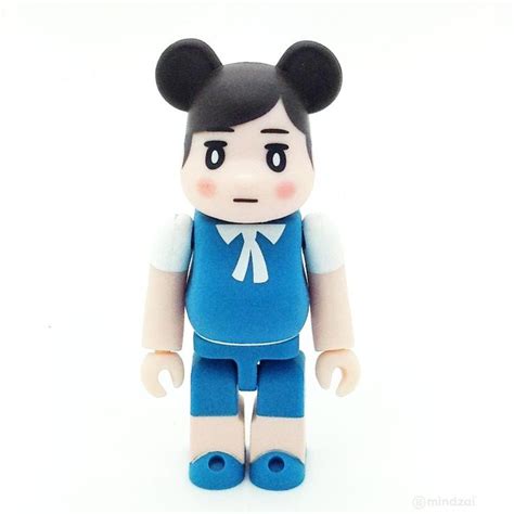 A Close Up Of A Toy With A Person Wearing A Blue Shirt And Pants On