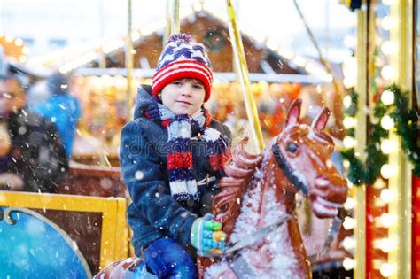 Adorable Kid Boy Riding On Animal On Roundabout Carousel In Amusement