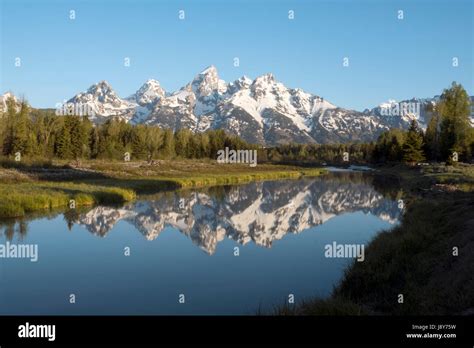 Sunrise In Grand Teton National Park Teton Mountains Reflected In A