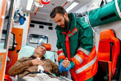 Premium Photo A Male Paramedic In Uniform Measures The Pulse Of A