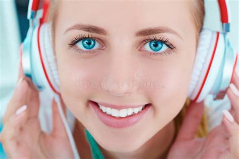 Woman Listening Music With Headphones From A Smart Phone Stock Image