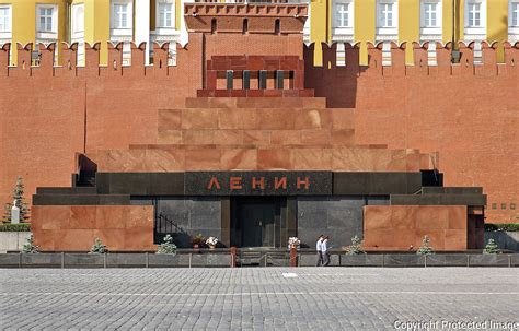 two policemen walk past the facade of lenin s mausoleum red square russia quintin lake