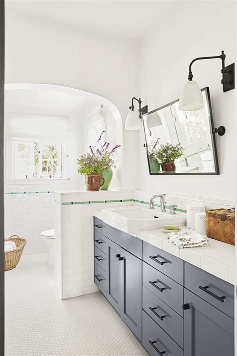 Soft peach backsplash and brown accent walls exhibit a tranquil atmosphere. Grey Bathroom Countertops - Bathroom Design Ideas
