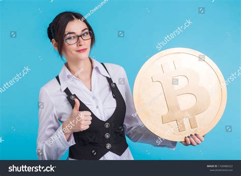 Happy Young Girl Holding Golden Bitcoin Winking Thinking About Crypto