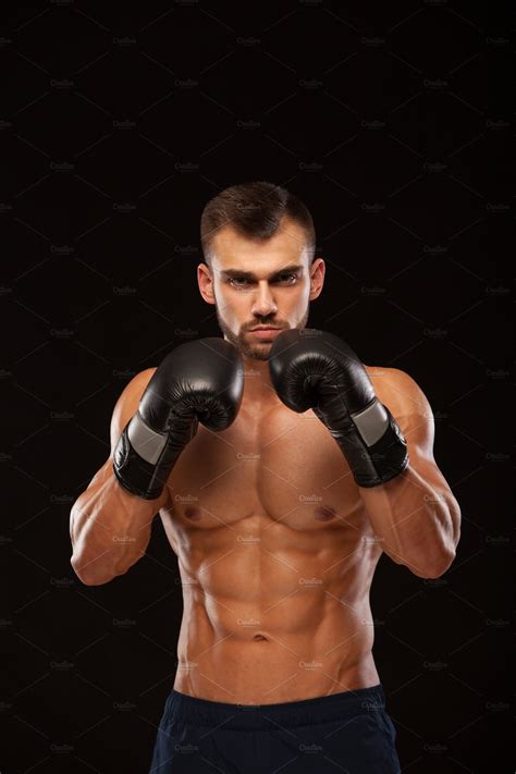 Muscular Young Man With Perfect Torso With Six Pack Abs In Boxing