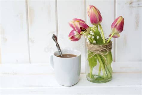 Cup Of Coffee With Lilac And Tulips Flowers For Good Morning Stock