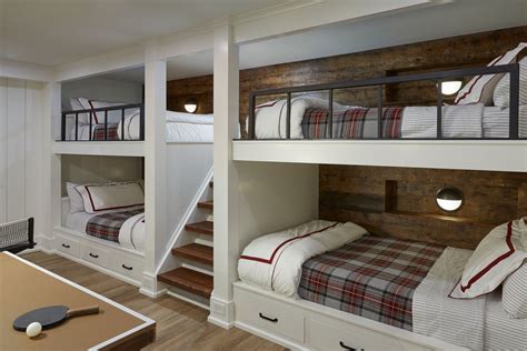 Bunk Beds In A Room With Wooden Floors And White Walls Along With