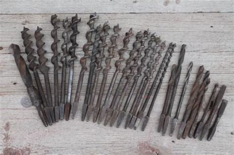 Many Different Tools Are Laying Out On The Floor Together Including Drill Heads And Nails