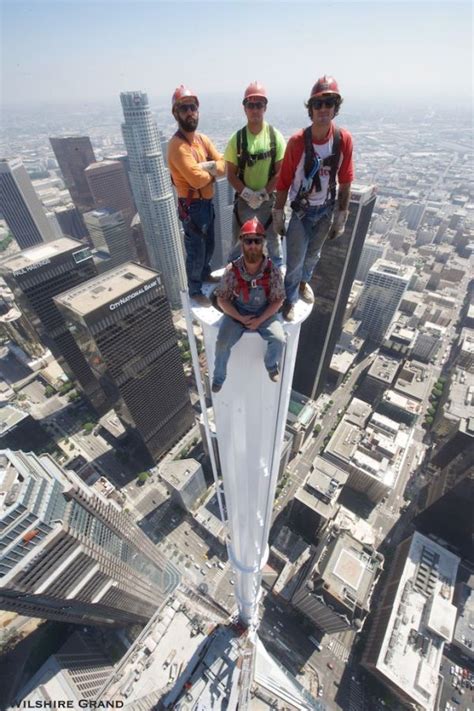 Photo Of Four Guys Standing On Spire Atop Las Tallest Building