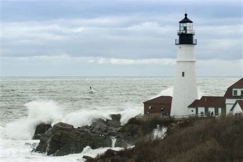 Waves Crashing On Rocks By Maine Lighthouse As Storm Passes Stock Image