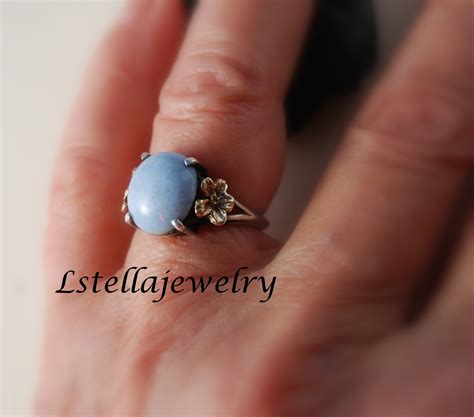Ring Ladies With Blue Larimar Stone And Flowers On The Sides In 14k