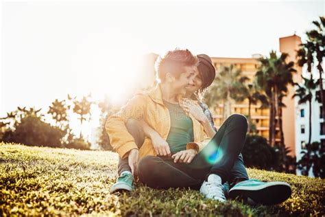 Happy Gay Couple Embracing And Laughing Together In Park Outdoor