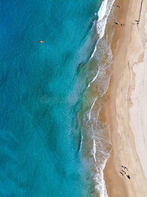 Aerial Shot Of People Enjoying The Beach On A Sunny Day Stock Photo