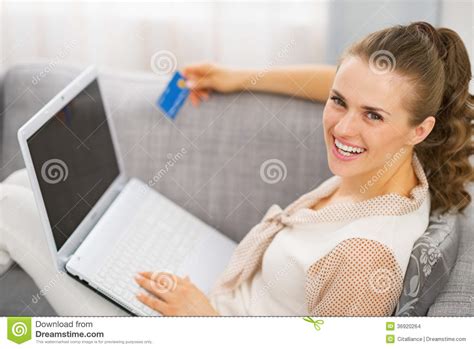Portrait Of Smiling Young Housewife With Credit Card And Laptop Stock