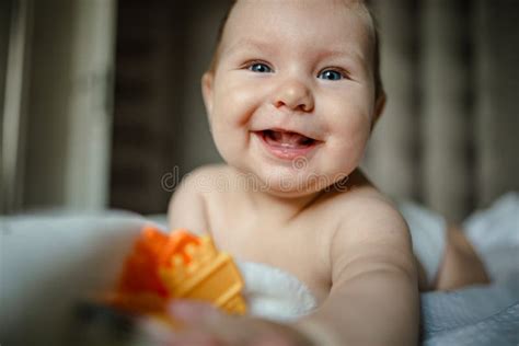 Cute Happy 6 Month Baby Boy In Diaper Lying And Playing Stock Image
