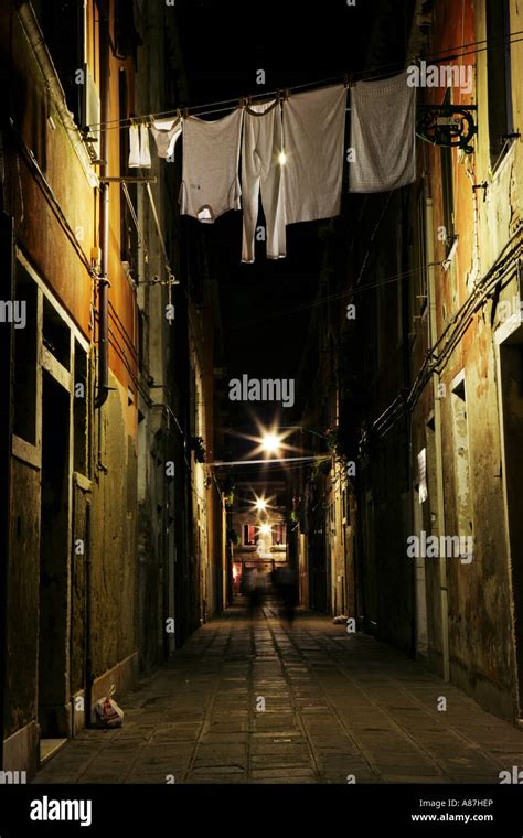 Clothes Hanging From Clothesline In Alley Low Angle View Stock Photo