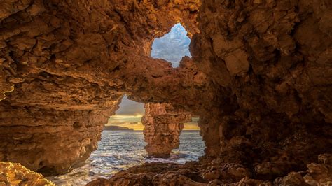 Download Wallpaper 2560x1440 Cave Stones Sea Rocks Widescreen 169
