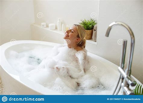 Happy Cheerful Pretty Female Enjoying Bubbles And Hot Water In Bathtub Spa And Relax Day Stock