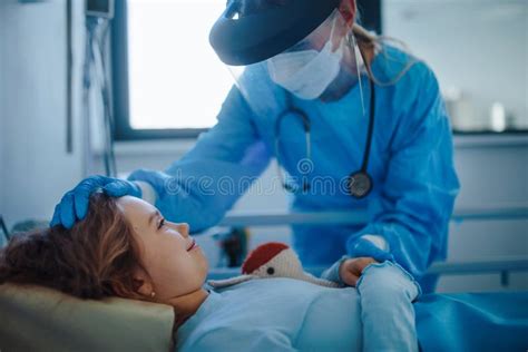 Friendly Woman Doctor Taking Care And Playing With Little Girl Stock