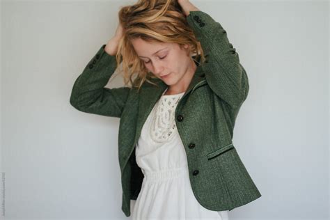 Girl With Blonde Hair Modelling A Green Jacket And A Summer Dress By