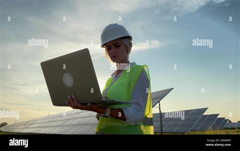 Inspector Engineer Woman Holding Digital Laptop Working In Solar Panels
