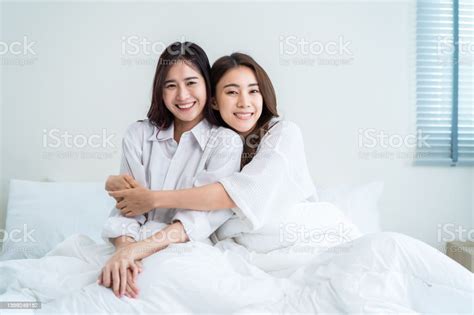portrait of asian beautiful lesbian couple hugging and look at camera attractive romantic girl