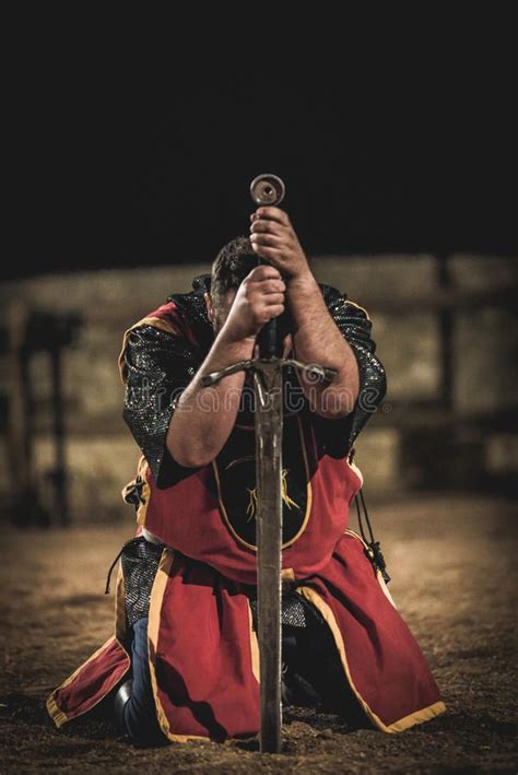 Medieval Knight Kneeling With Sword After Battle Stock Photography