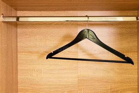 Single Empty Black Clothing Rack Hanging On Coathanger In Closet Stock