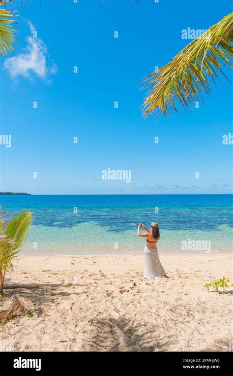 Woman Taking Photographs On A Tropical Beach Drawaqa Island Yasawa