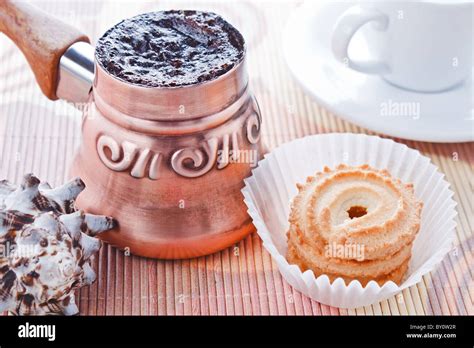 Freshly Brewed Hot Turkish Coffee In Copper Coffee Pot With Cup