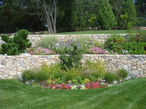 A wall that cuts into a level lawn and forms a sunken garden room creates a microclimate that extends the. Retaining Walls — Joyce Landscaping