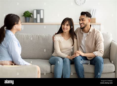 effective marital therapy happy middle eastern couple sitting on couch at counselor s office