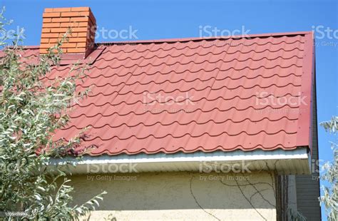 House With A Red Metal Roof And White Plastic Soffit Boards Roofing