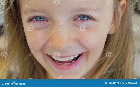 Close Up Portrait Of A Happy Little Girl Bursting In Laugh Slowly