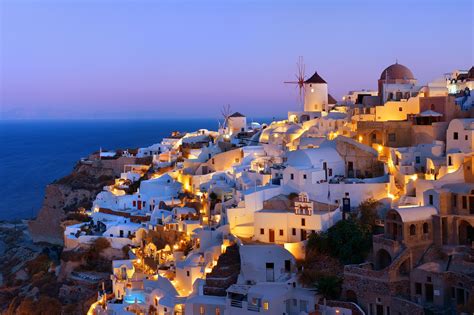 Santorini Skyline At Night With Buildings In Greece Go Places Holidays